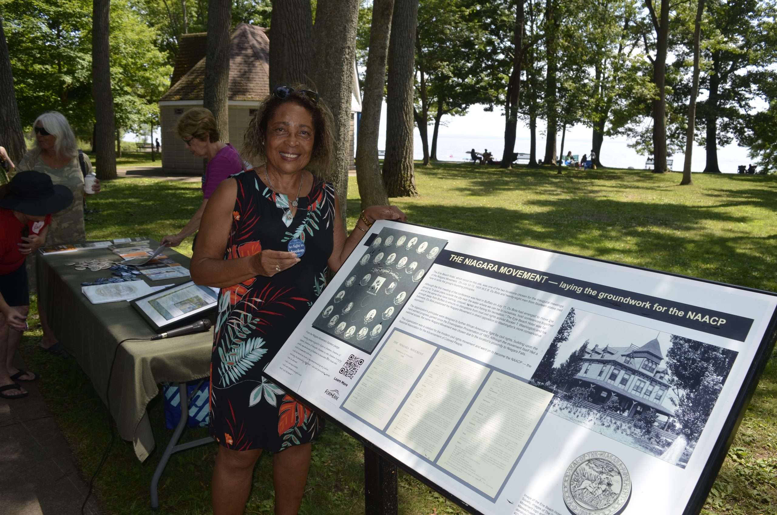 Lezlie Harper stands next to a Niagara Movement plaque at Waverly Beach Park.
