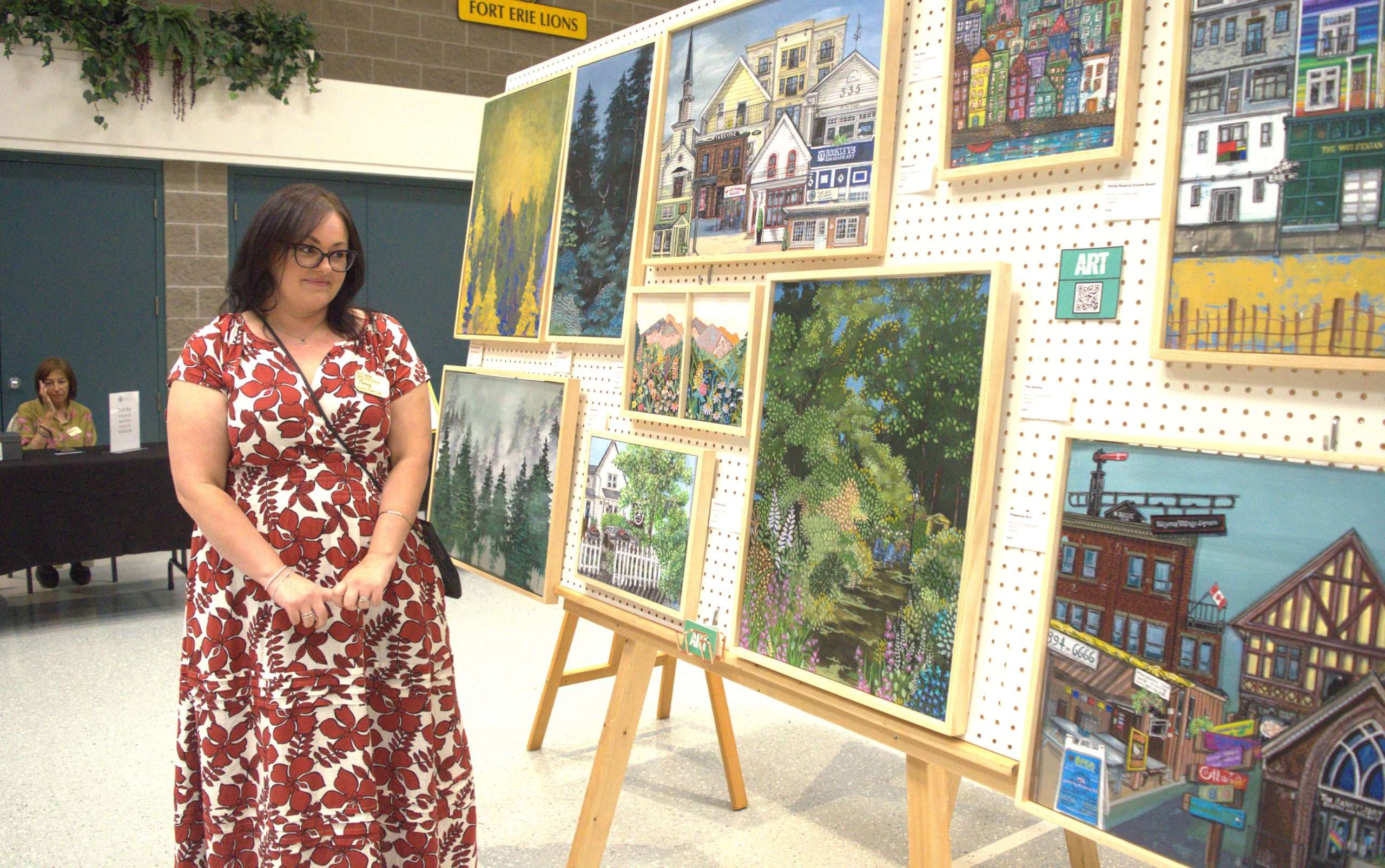 Artist looking at their artwork