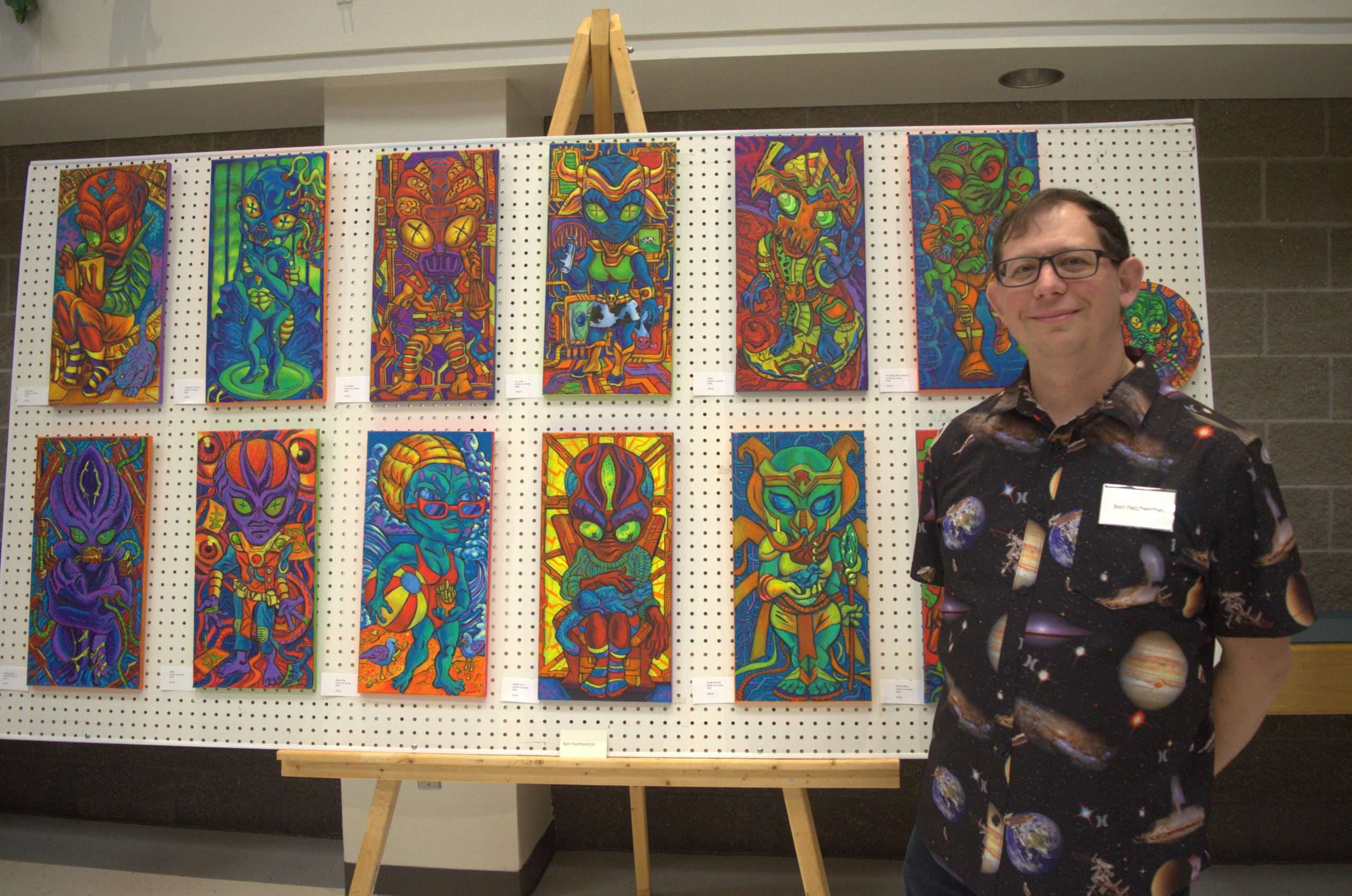 Artist standing in front of artwork