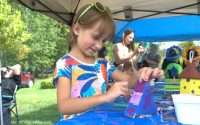 Girl painting a birdhouse